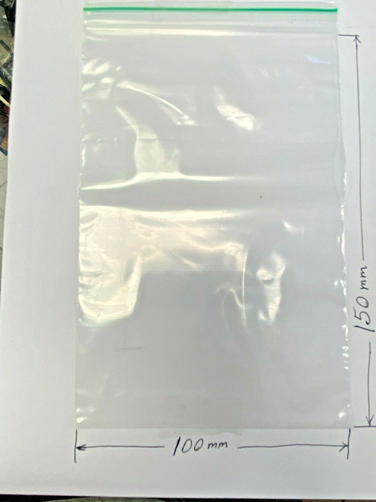 A clear plastic zip-top bag with a green seal, shown on a white background with  dimension markings indicating 100 mm width and 150 mm height.