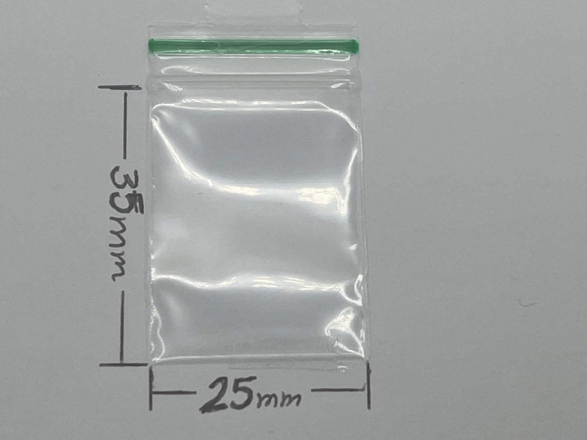 A clear plastic zip-top bag with a green seal, with dimension markings indicating 35 mm height and 25 mm width.