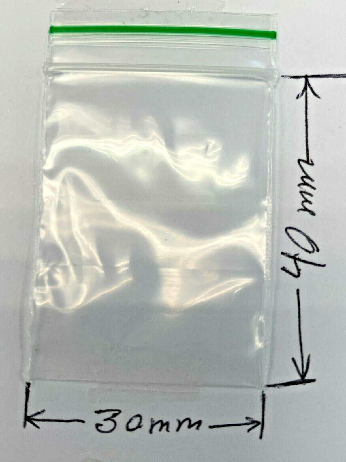 A clear plastic zip-top bag with a green seal strip, shown on a white background with dimension markers indicating 30mm by 40mm.