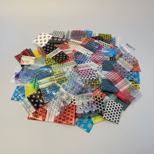 Assorted, mix 50x50mm (2x2 inch) printed resealable plastic zip bags and poly baggies in a variety of designs.