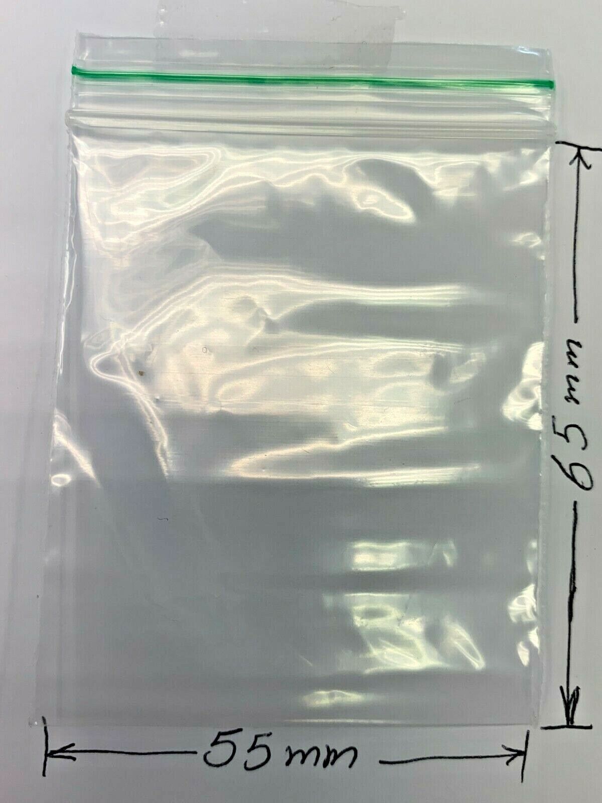 A clear plastic zip-top bag shown on a white background with measurements indicating 55 mm width and 65 mm height.