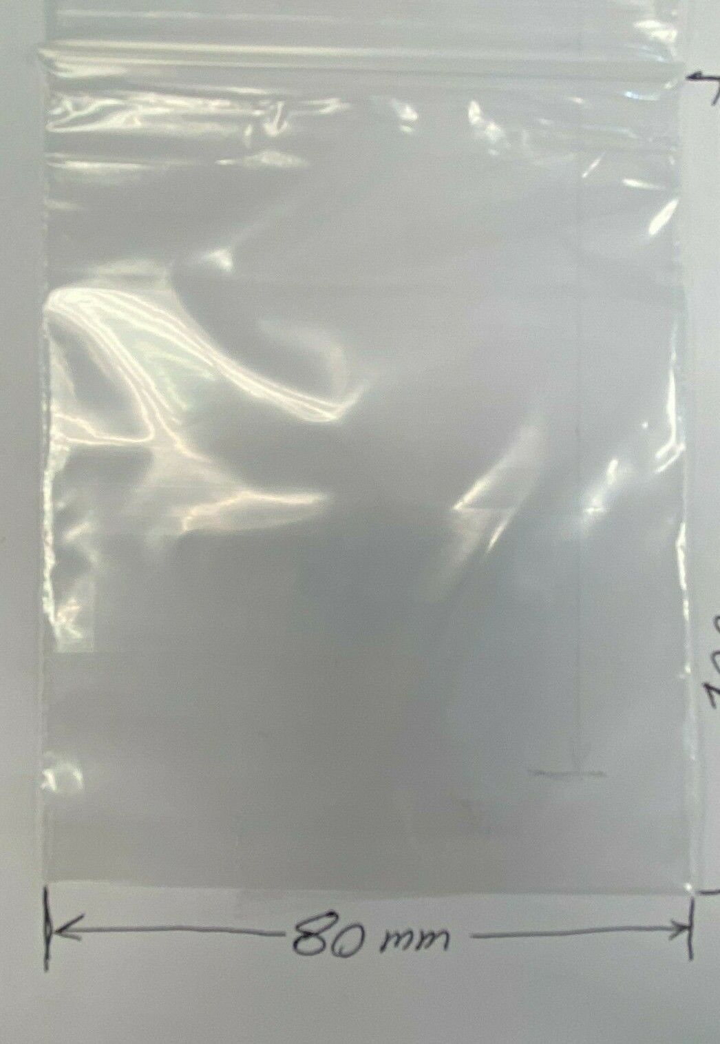 A clear plastic zip-top bag shown on a white background with a handwritten dimension marker indicating 80 mm x100 mm width.